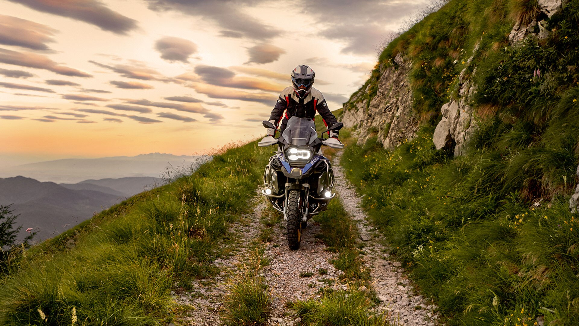 Riding scene with the BMW R 1250 GS Adventure in the mountains on unpaved road