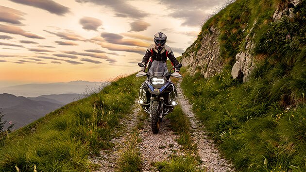 Riding scene with the BMW R 1250 GS Adventure in the mountains on unpaved road